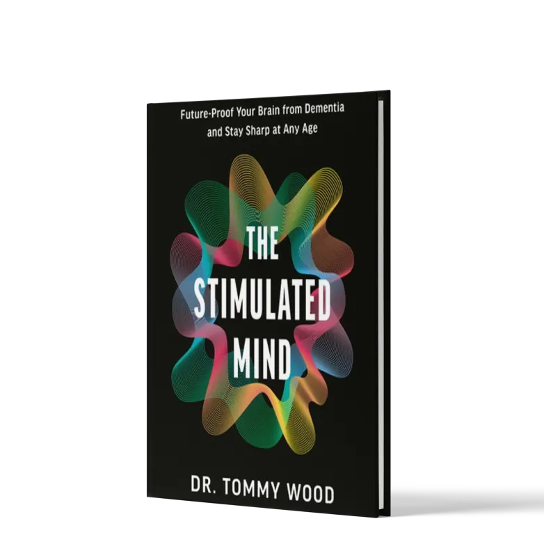 Book titled The Stimulated Mind by Dr. Tommy Wood with colorful abstract brain wave design on black cover.